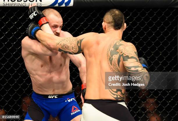 Santiago Ponzinibbio of Argentina punches Gunnar Nelson of Iceland in their welterweight bout during the UFC Fight Night event at the SSE Hydro Arena...