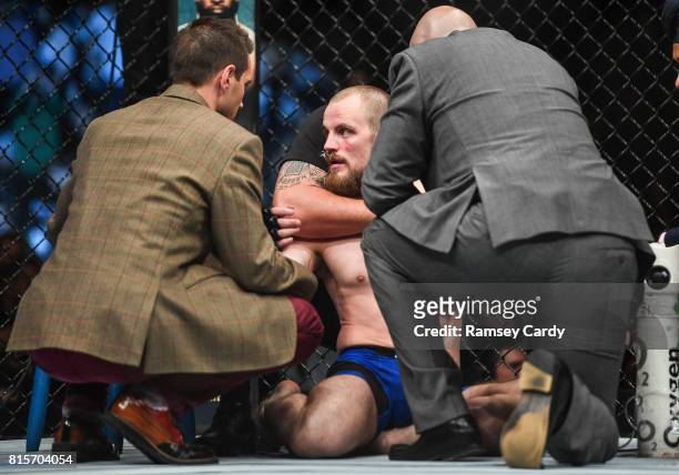 Glasgow , United Kingdom - 16 July 2017; Gunnar Nelson, right, recovers from being knocked out by Santiago Ponzinibbio in the first round of their...