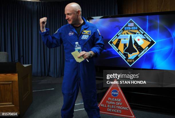 Astronaut Commander Mark Kelly leaves a press conference after US space shuttle Discovery landed at the Kennedy Space Center on June 14, 2008....