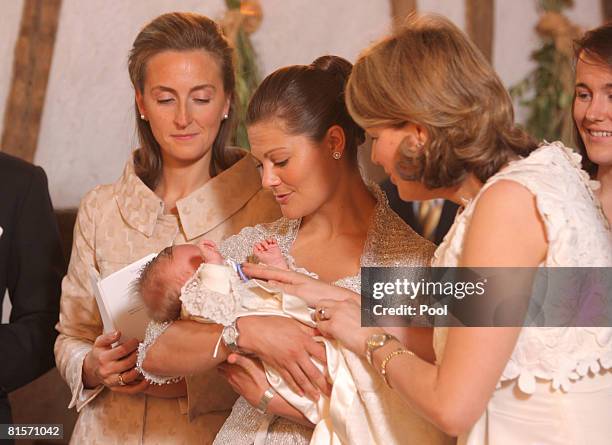 Princess Claire of Belgium, Princess Victoria of Sweden holding Princess Eleonore of Belgium and Princess Mathilde of Belgium during the baptism of...