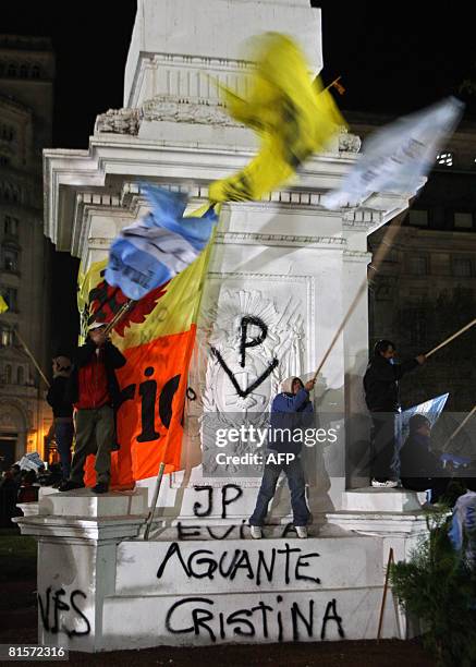 People wave flags at the Plaza de Mayo square during a demonstration backing the government's decisions in relation with the farmers' conflict on...