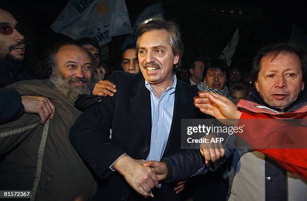 Argentina's Chief of Cabinet Alberto Fernandez is greeted by supporters at the Plaza de Mayo square during a demonstration backing the government's...