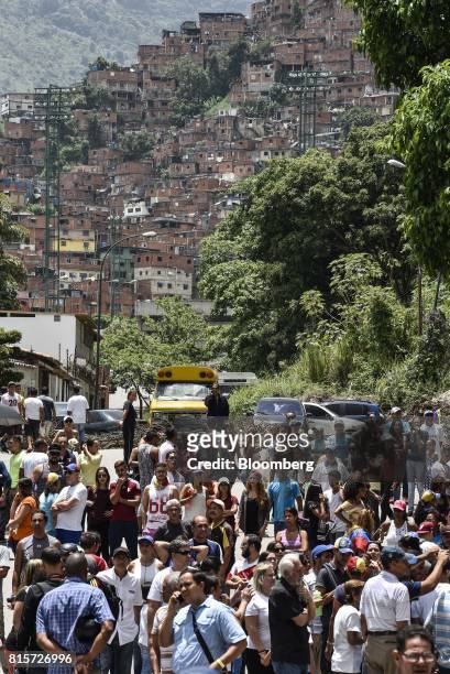 Voters wait to cast their ballots at a polling station during a symbolic Venezuelan plebiscite in Caracas, Venezuela, on Sunday, July 16, 2017....