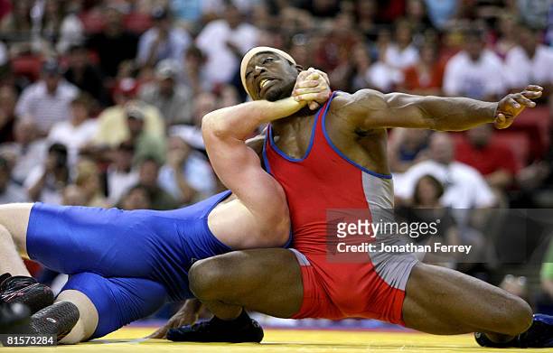 Dantzler endures a choke hold by Cheney Haight in the Greco-Roman 74kg division championship match during the USA Olympic trials for wrestling and...