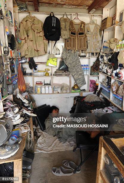 Afghanistan-unrest-US-army,FEATURE by Thibauld Malterre In this photograph taken on June 9 an Afghan shopkeeper sleeps in his shop in Bagram, some 50...