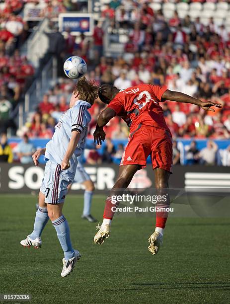 Midfielder Rohan Ricketts of Toronto FC jumps for the header with captain Tom McManus of the Colorado Rapids during their game on June 14, 2008 at...