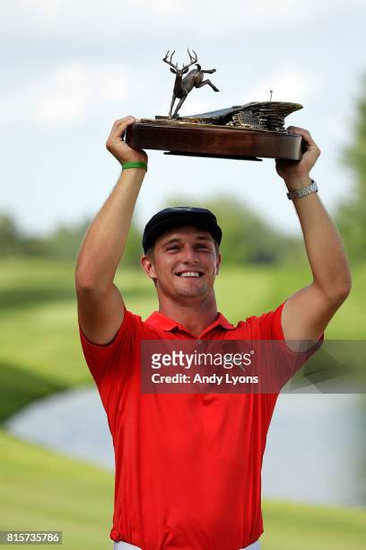 Bryson DeChambeau poses with the championship trophy following the final round of the John Deere Classic at TPC Deere Run on July 16, 2017 in Silvis,...