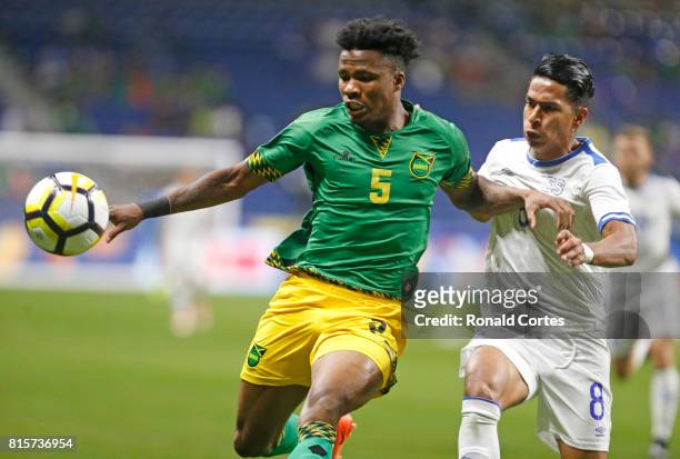 Alvas Powell of Jamaica tries to advance the ball against a defending Ivan Mancia of El Salvador in the first half during the 2017 CONCACAF Gold Cup...