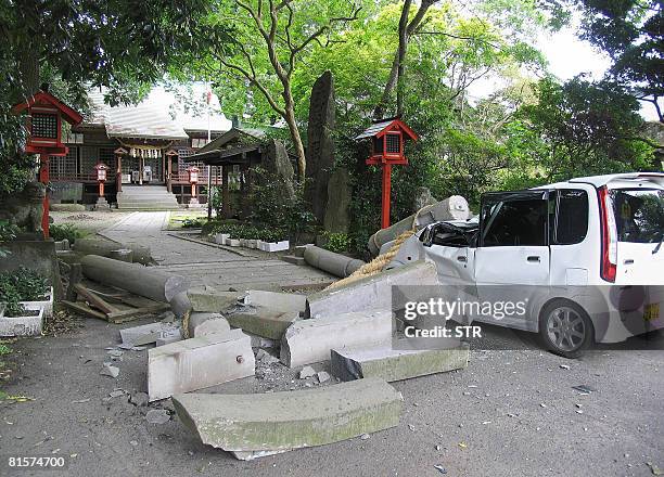 Stone gateway to a Shinto shrine collapse on a car in Ichinoseki, northern Japan, on June 14, 2008. A powerful earthquake struck northern Japan on...