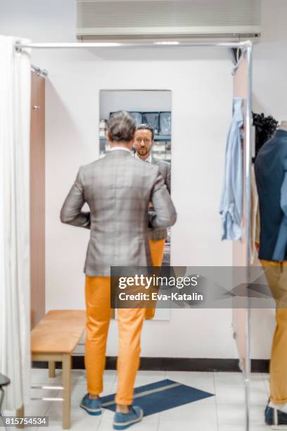 young man in a fitting room - fitting room stock pictures, royalty-free photos & images