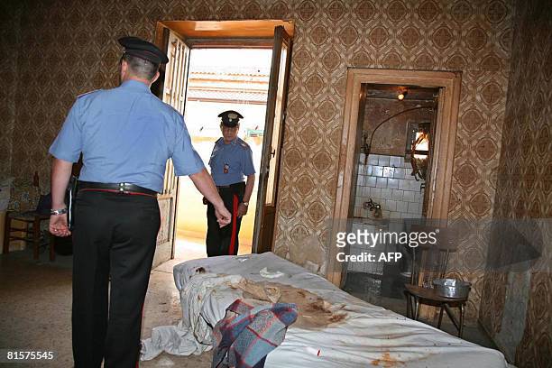 Italian policemen inspect the house where a middle-aged woman was shut in by her family for 18 years, in Santa Maria Capua Vetere, north of Naples on...