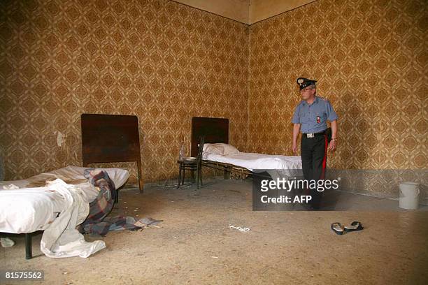 An Italian policeman inspects the house where a middle-aged woman was shut in by her family for 18 years, in Santa Maria Capua Vetere, north of...