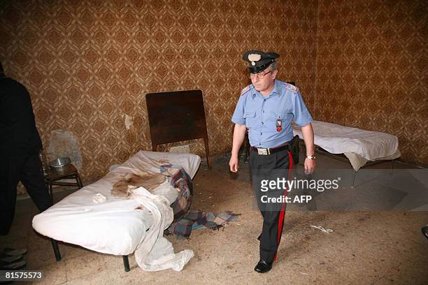 An Italian policeman inspects the house where a middle-aged woman was shut in by her family for 18 years, in Santa Maria Capua Vetere, north of...