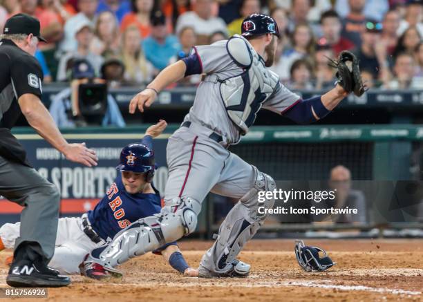 Minnesota Twins catcher Chris Gimenez tags Houston Astros second baseman Jose Altuve too late during the MLB between the Minnesota Twins and Houston...