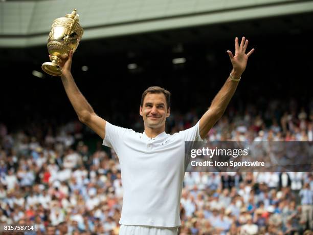 Roger Federer poses with the trophy after winning men's singles title during the Wimbledon Championships on July 16, 2017 at the All England Lawn...