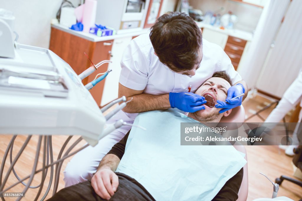 Dentist Doctor doing Surgery on Screaming Scared Patient