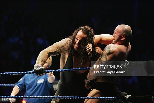 The Undertaker pushes Bam Neely into the corner during WWE Smackdown at Acer Arena on June 15, 2008 in Sydney, Australia.