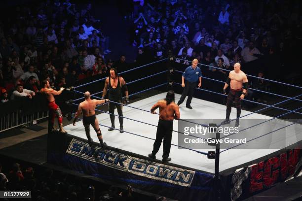 The Undertaker and ECW Champion Kane stand in the ring as they look towards Bam Neely, Chavo Guerrero, and The Great Khali during WWE Smackdown at...