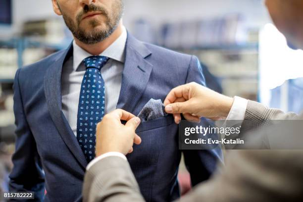 a personal stylist helping his customer - necktie stock pictures, royalty-free photos & images