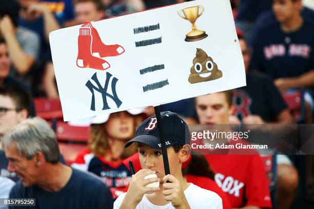 Young fan holds a sign with emojis during game two of a doubleheader between the Boston Red Sox and the New York Yankees at Fenway Park on July