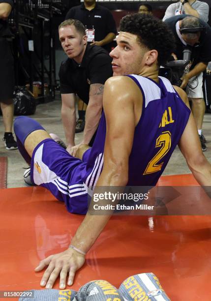 Lonzo Ball of the Los Angeles Lakers has his right leg worked on by a trainer during the second half of a semifinal game of the 2017 Summer League...
