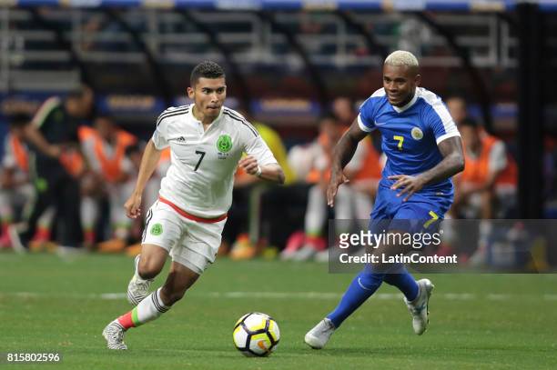 Orbelin Pineda of Mexico and Leandro Bacuna of Curacao compete for the ball during a Group C match between Mexico and Curacao as part of CONCACAF...