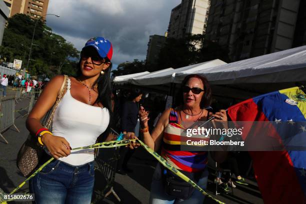 People celebrate after voting during a symbolic Venezuelan plebiscite in Caracas, Venezuela, on Sunday, July 16, 2017. Millions of Venezuelans...