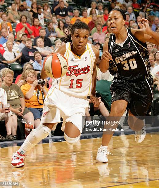 Tan White of the Indiana Fever drives on Helen Darling of the San Antonio Silver Stars at Conseco Fieldhouse on June 15, 2008 in Indianapolis,...