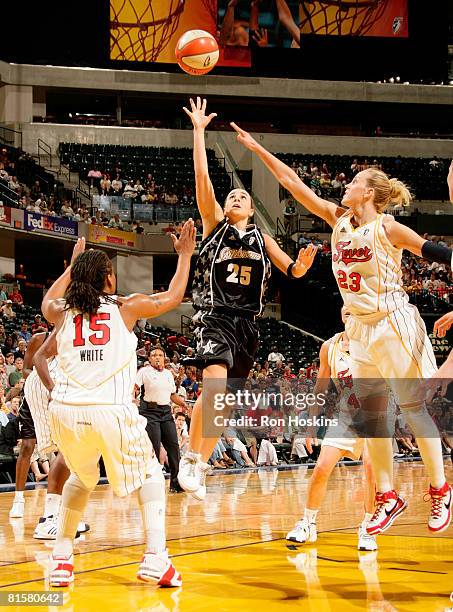 Becky Hammon of the San Antonio Silver Stars shoots over Katie Douglas and Tan White of the Indiana Fever at Conseco Fieldhouse on June 15, 2008 in...