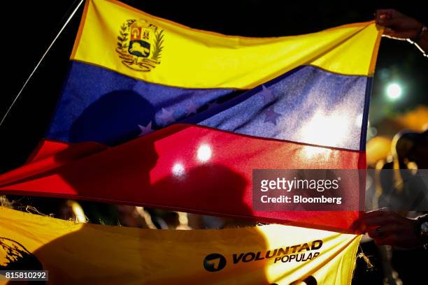 Venezuelan flag is displayed as people celebrate during a symbolic Venezuelan plebiscite in Caracas, Venezuela, on Sunday, July 16, 2017. Millions of...