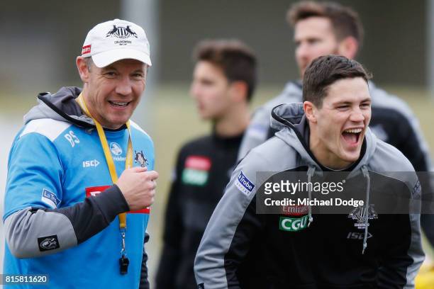 Jack Crisp of the Magpies reacts next to assistant coach Brenton Sanderson during a Collingwood Magpies AFL training session at Gosch's Paddock on...