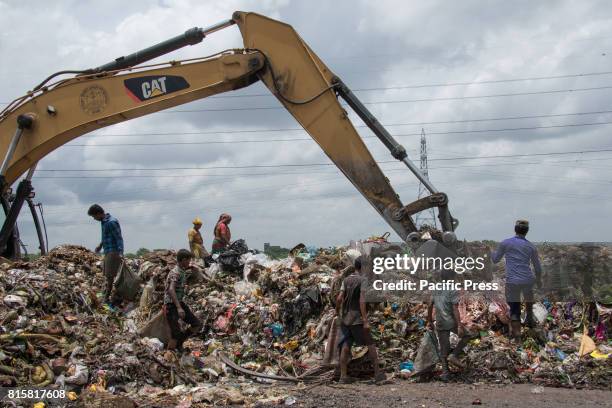 People sift through mountains of rubbish searching for anything reusable or recyclable they can sell - although it will earn them less than $3 a day....