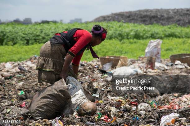 Woman sift through mountains of rubbish searching for anything reusable or recyclable they can sell - although it will earn them less than $3 a day....