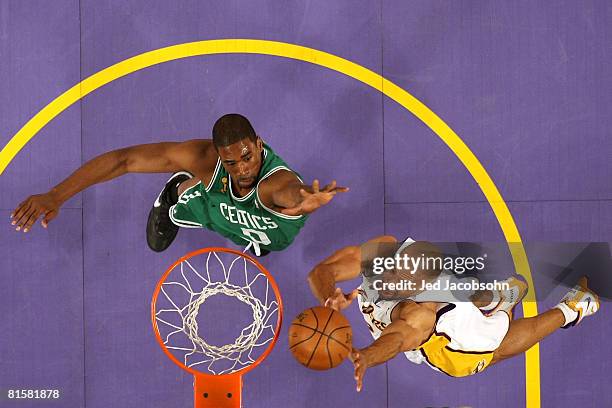 Derek Fisher of the Los Angeles Lakers lays the ball up over Leon Powe of the Boston Celtics in Game Five of the 2008 NBA Finals on June 15, 2008 at...