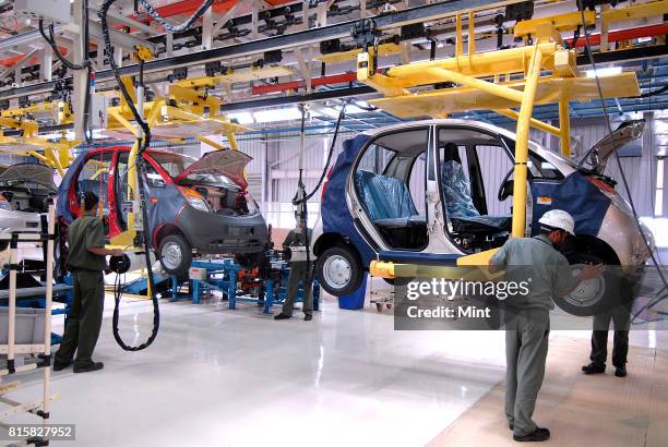 Workers working on the Tata Nano assembly line at the newly inaugurated Tata Motors plant in Sanand, Gujarat.