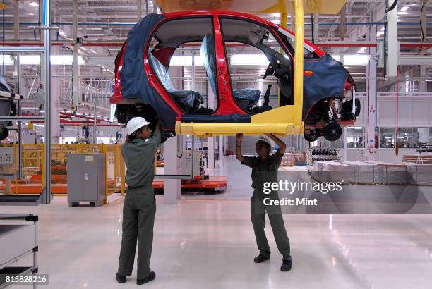 Workers working on the Tata Nano assembly line at the newly inaugurated Tata Motors plant in Sanand, Gujarat.