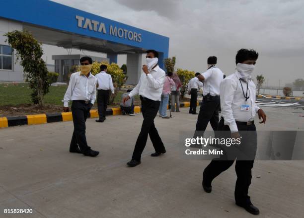 Staff of Tata Motors trying to control the panic, as sudden cyclonic winds disrupted the inauguration event of Tata Motors plant, causing major...