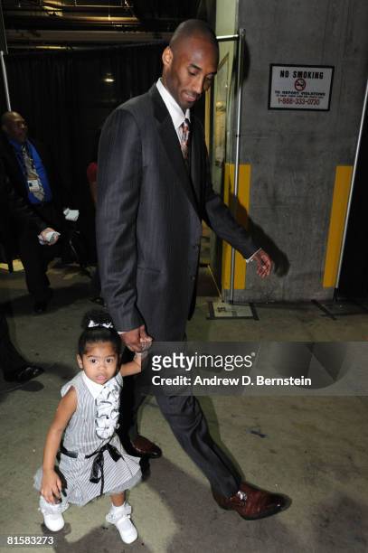 Kobe Bryant of the Los Angeles Lakers walks out of the arena with daughter Gianna following his team's victory over the Boston Celtics in Game Five...