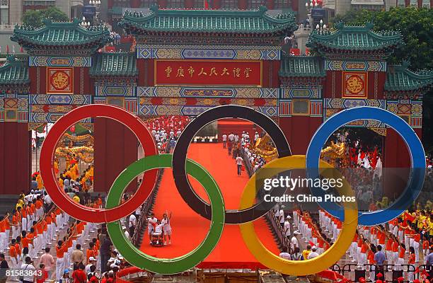 Torchbearer Liu Gangjun from the Sichuan earthquake-struck area, carries the Olympic flame during the Chongqing leg of Beijing Olympic torch relay...