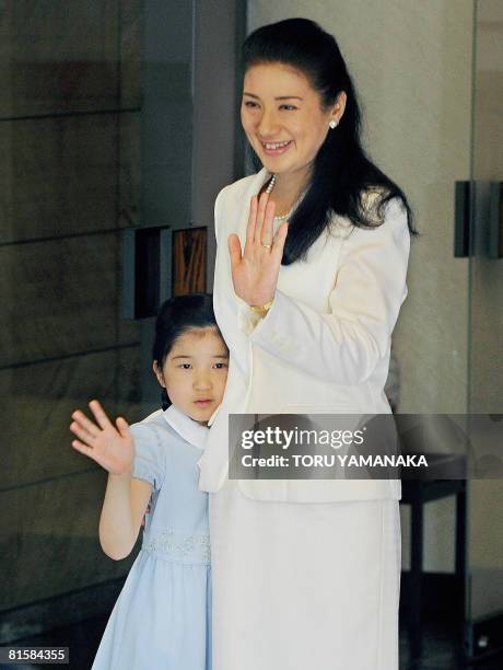 Japanese Crown Princess Masako and her daughter Princess Aiko wave to Crown Prince Naruhito at the entrance of the Togu Palace in Tokyo on June 16,...