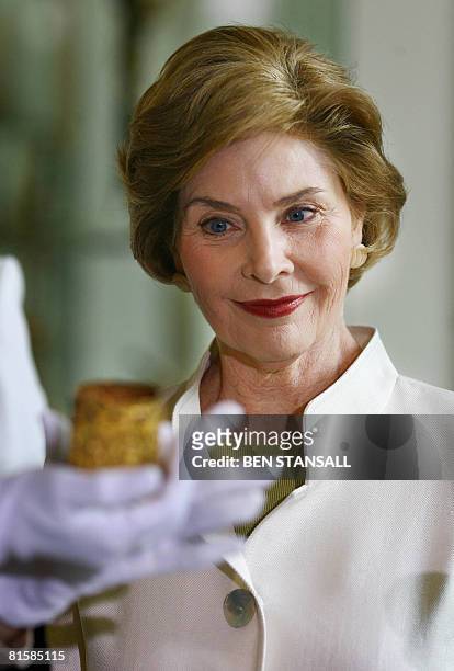 First Lady Laura Bush looks at an artefact during a visit to the British Museum in London on June 16 2008. First Lady Laura Bush visited the Charles...