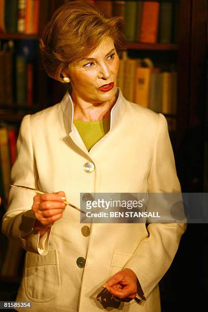 First Lady Laura Bush holds a quill pen used by Charles Dickens during a visit to the Charles Dickens Museum in London, on June 16, 2008. First Lady...