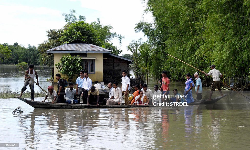Indian travellers use a country boat to
