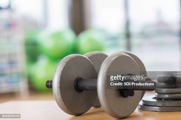 dumbbells on gym floor - hand weight stock pictures, royalty-free photos & images
