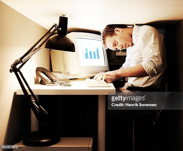 man working in a very small office. - too big stock pictures, royalty-free photos & images