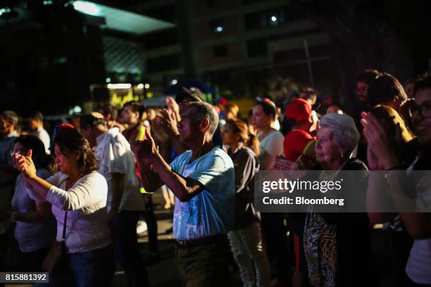 People applaud as partial results are announced during a symbolic Venezuelan plebiscite in Caracas, Venezuela, on Sunday, July 16, 2017. Millions of...