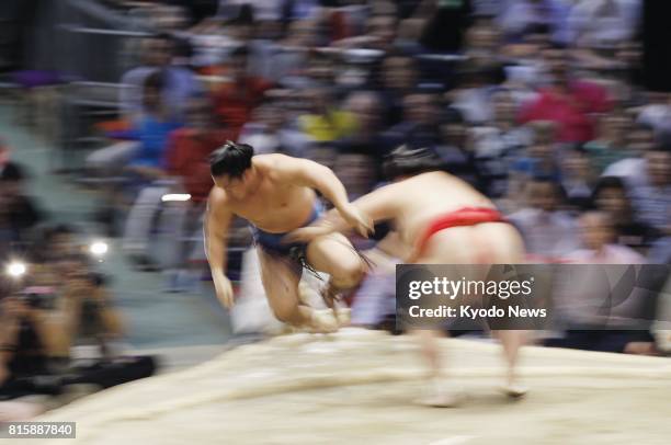 Onosho pushes Ishiura out and off the dohyo ring during the Nagoya Grand Sumo Tournament in Nagoya, central Japan, on July 13, 2017. ==Kyodo