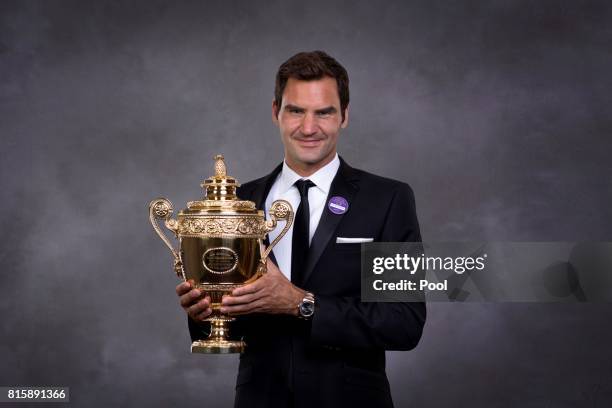 Roger Federer poses with the trophy at the Wimbledon Winners Dinner at The Guildhall on July 16, 2017 in London, England.