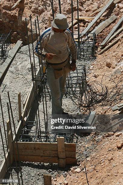 Palestinian laborer works at a construction site in the religious neighborhood of Ramat Shlomo, the latest Israeli development on land it captured...