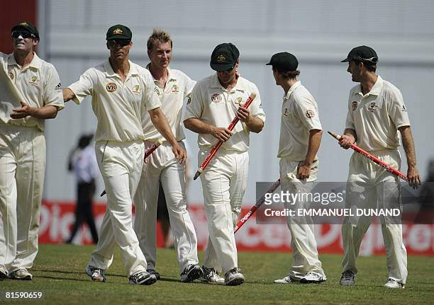 Australian cricket players carry the stumps celebrating their victory over the West Indies, at the end of the fifth and last day of the third test...